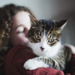 Young woman with her tabby cat