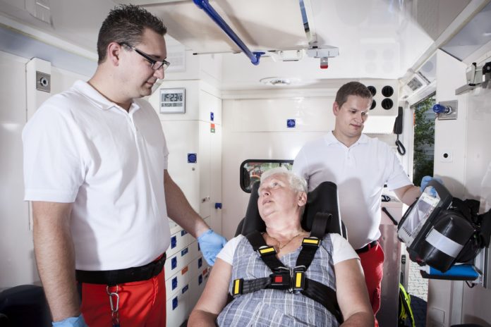 Paramedics ambulance medical equipment emergency senior woman