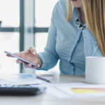 businesswoman-checking-smartphone-close-up