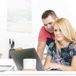 young-couple-looking-laptop-screen