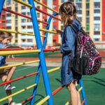 Elementary school students playing on the school playground.