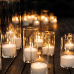 Burning candles in the transparent glass candlestick on the floo